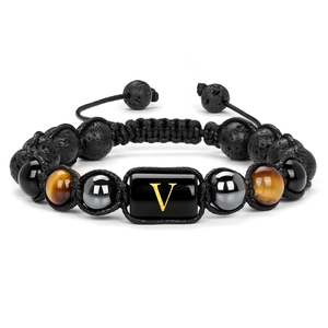 Macro shot of 10mm lava rock and tiger eye beads with a gold letter V charm on a bracelet