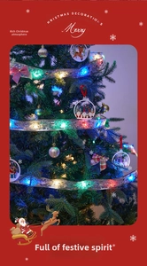 Close-up of silver LED Christmas ribbon lights with multi-colored bulbs on tree