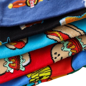 Detailed macro view of colorful knitted cotton socks with vibrant cartoon food patterns