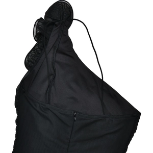 Detail of black one-shoulder mesh dress showing the zipper and ruched fabric texture