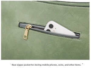 Detail view of back zipper pocket on green faux leather tote bag holding a smartphone