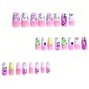 Y2K style press-on nails with pink gradient, music notes, and star patterns in a 24pc set