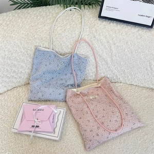 Detail of floral lace mesh tote bag with white pearl beads in light blue and pink