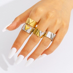 Wide stainless steel heart rings in gold and silver finish shown on a hand