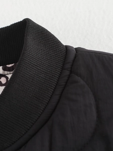 Macro detail of ribbed collar and quilted fabric on a black casual jacket with lining