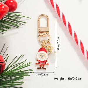 Christmas Santa Claus keychain with lobster clasp and white pearl charm on festive background