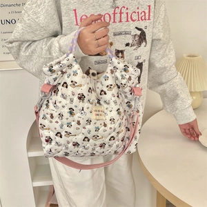 Close-up of quilted cotton tote bag featuring cartoon print and woven handles