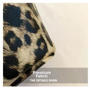 Macro detail of leopard print tote bag showing premium pebbled leather texture and stitching