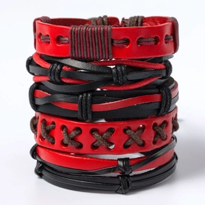 Macro detail of red and black braided leather bracelets in a punk hip-hop style jewelry set