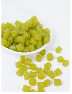 Macro detail of miniature green pickled bean props in a white ceramic bowl for DIY crafts