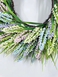 Close-up of colorful artificial lavender wreath with pink and purple buds on vine base