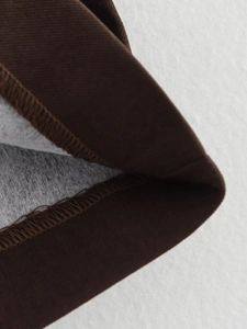 Detail of brown suit fabric showing soft fleece lining and high-quality sewing