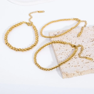 Three-piece stackable 18K gold plated stainless steel bead bracelets with adjustable clasp