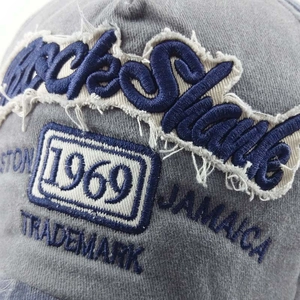 Close-up of vintage washed cotton baseball cap with intricate 1969 Rock Shake embroidery