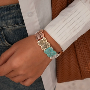 Detailed view of vintage embossed oval charms on a bohemian stretch bracelet for women