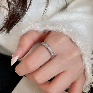 Close-up of silver zircon ring with pearl detail and vintage beaded edges on model hand