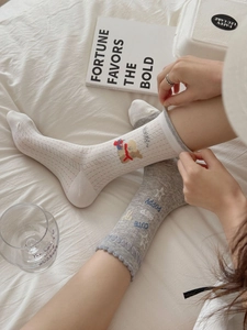 Close-up of breathable mesh cotton crew socks with cute cartoon puppy embroidery