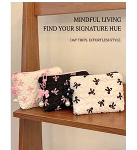 Quilted makeup bag with bow patterns and pearl pendants in three color contrast designs