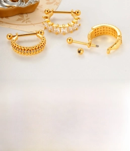 Macro detail of gold-plated U-shaped ear studs with premium zircon and screw backings