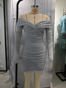 Detail of grey glitter off-the-shoulder dress with ruched fabric and shimmer finish