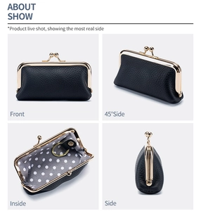 Detail view of black litchi grain leather coin purse with gold kiss-lock and polka dot lining