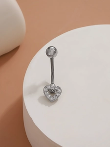 Macro shot of silver heart navel ring with crystal pave setting on white display
