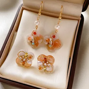 Vintage floral pearl drop earrings with clover studs in a luxury jewelry box