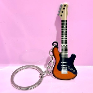Detail of guitar keychain with orange gradient finish and silver metallic chain