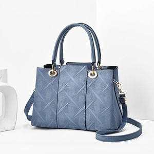 Elegant misty blue embossed handbag for women with golden hardware and shoulder strap