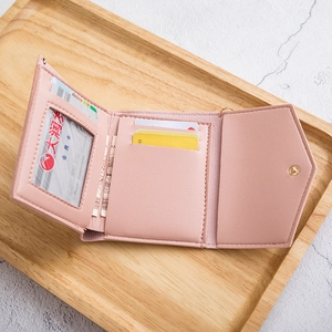 Pink faux leather tri-fold wallet for women with tassel, multiple card slots and snap button