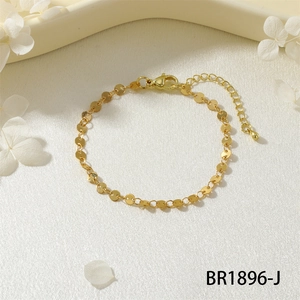 Dettaglio del bracciale a maglie dorate con chiusura a moschettone regolabile su seta