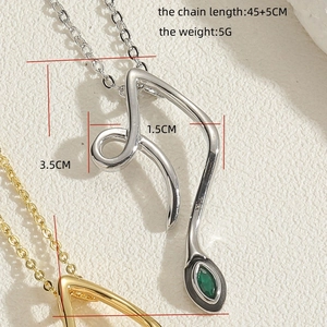 Macro detail of abstract curve necklace with green zircon gemstone and silver chain