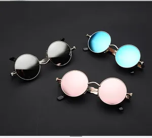 Detail view of round punk sunglasses with metallic hinges and reflective lenses