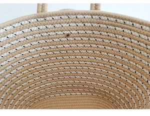 Close-up of the large straw tote bag showing detailed beige and white cotton rope weaving