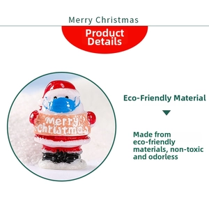 Detail of eco-friendly Santa figurine with blue mask and Merry Christmas banner decor