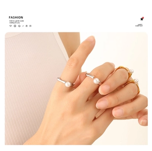 Close-up of elegant gold and silver irregular open rings with lustrous pearls