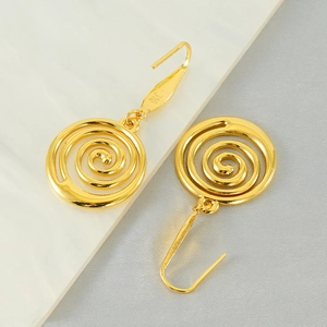 Close-up of gold spiral earrings showing the L316 stainless steel hallmark on the hook