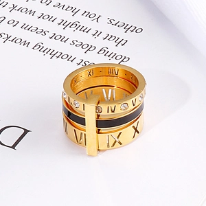 Macro shot of gold-plated multi-layer ring with Roman numerals and small diamonds