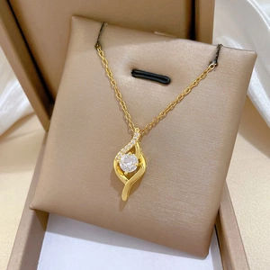 Macro shot of gold-plated necklace with sparkling round zircon in a luxury jewelry box