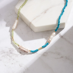 Baroque pearl turquoise peridot beaded S925 silver necklace on marble base
