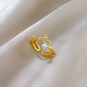 Detail of gold-plated fishtail ring with white pearl and micro-pave zircons on satin
