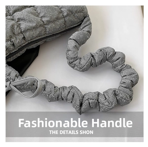 Detail of silver quilted handbag featuring unique bubble textured ruched handles
