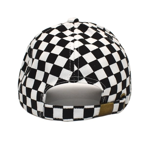 Detail view of the black and white checkered baseball cap with bronze metal adjustment buckle
