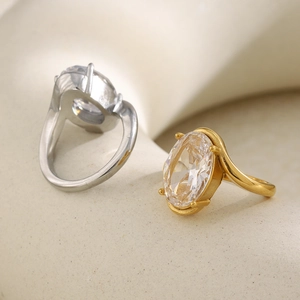 Detailed view of luxury gold and silver rings with oval zircon on a stone pedestal