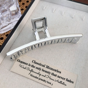 Detail of silver metallic heart hair claw clip with a polished finish and sturdy spring