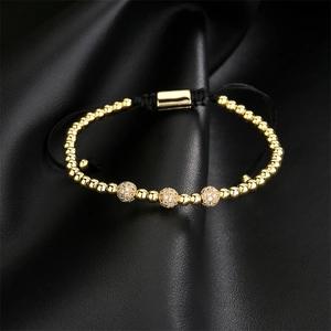Detailed macro shot of adjustable gold bead bracelet with micro-pave zircon charms