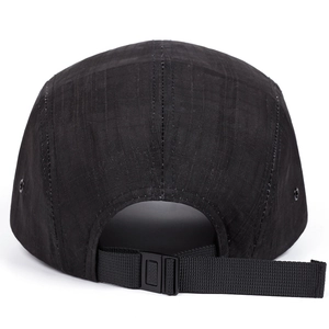Detail view of black five-panel camping hat with adjustable buckle strap and ripstop fabric