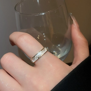 Detail of 18k gold plated double-layered ring with zircon accents and wavy mother-of-pearl