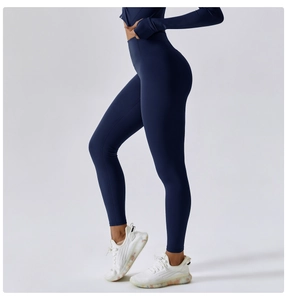 Detail of high-waist yoga leggings in dark blue showing seamless compression fabric