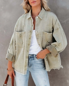 Detail of distressed olive denim jacket with frayed edges and oversized pockets